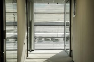 Modern office space with horizontal blinds providing light control and privacy, creating a comfortable and well-lit environment.