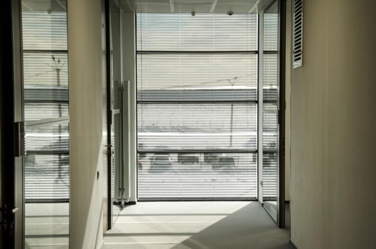 Modern office space with horizontal blinds providing light control and privacy, creating a comfortable and well-lit environment.