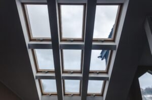 View of skylight windows in a modern room, showcasing advanced light control with multiple roof windows for ample natural light.