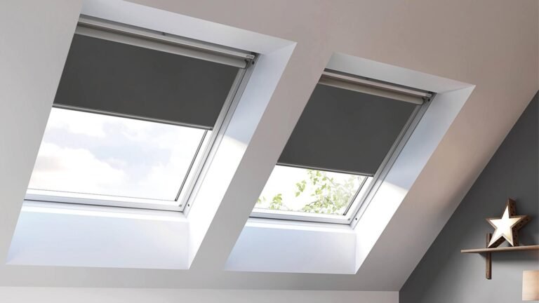 Skylight windows with dark roller blinds providing smart light control in a modern, elevated room setting.